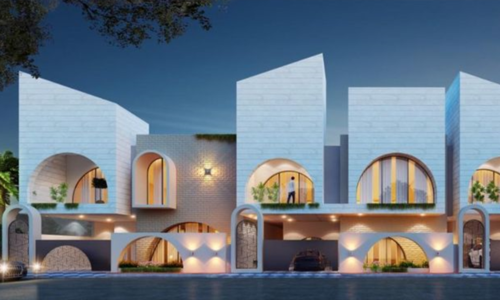Modern two-story houses at dusk with arched doorways and illuminated by warm lights.
